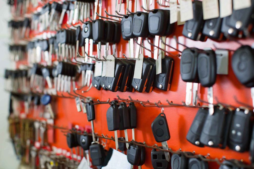 Professional automotive locksmith replacing a car key